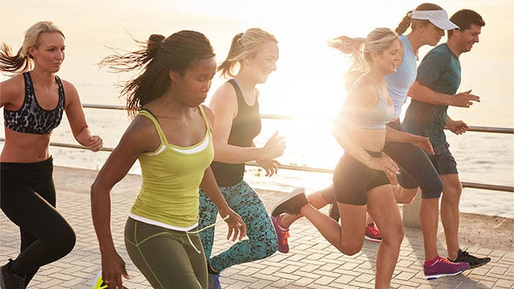 active people running on the beach