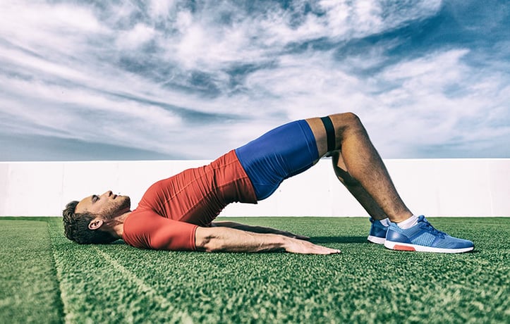 a man training glutes with a resistance band
