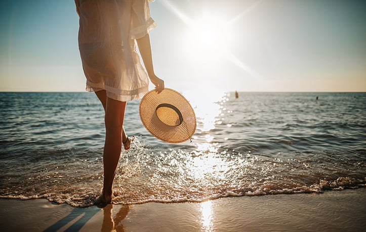 a woman at the beach on a wellness retreat